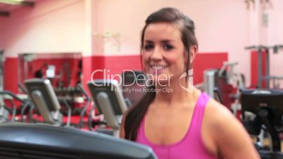 Smiling woman running on treadmill