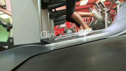 Three people running on treadmills