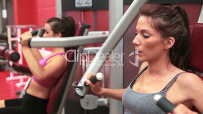 Women training on weights machine