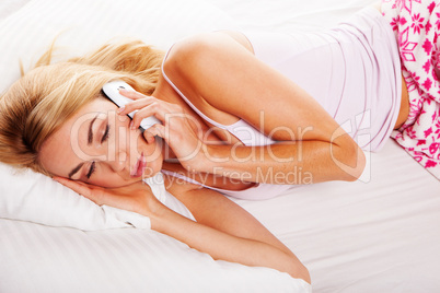 Sleepy woman answering a phone call