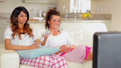 Woman sitting on the couch watching tv