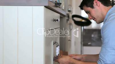 Man repairing kitchen press