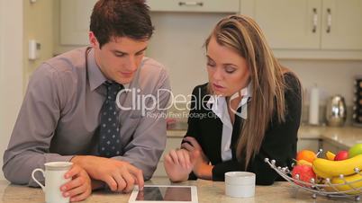Couple looking at tablet pc and talking