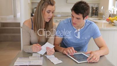 Couple calculating with tablet pc