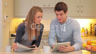 Man showing woman something on tablet pc