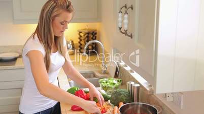 Woman chopping peppers