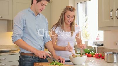 Couple is preparing salad together