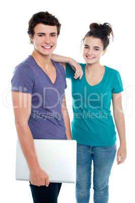 Handsome guy holding laptop posing with his girlfriend