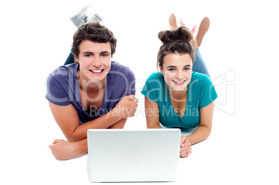 Teen friends enjoying video on laptop together