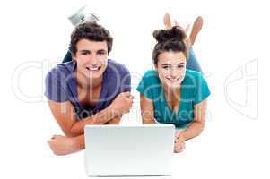 Teen friends enjoying video on laptop together