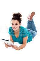 Pretty teenager watching movie on tablet pc