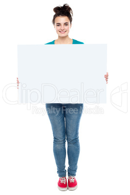 Full length portrait of stylish girl presenting banner ad