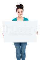 Adorable smiling teenager holding big ad board