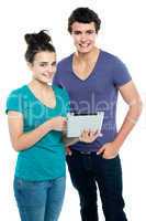 Technology savvy couple browsing newly launched tablet