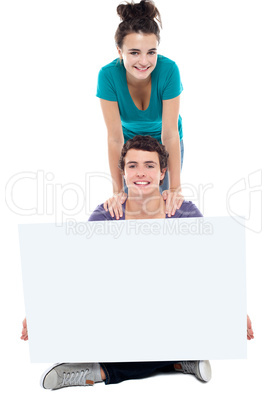 Teens advertising white blank billboard