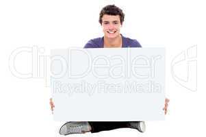 Teenager showing blank white billboard to camera