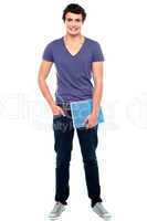 Stylish college student posing with notebook in hand