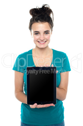 Casual teenager showing newly launched tablet device