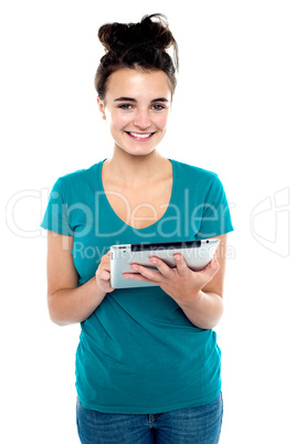 Pretty young brunette using wireless tablet device