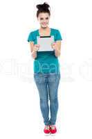 Full length portrait of pretty girl holding tablet pc