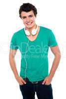 Cool trendy teenager boy with headphones around his neck