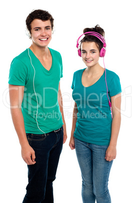 Friends enjoying music together via headphones