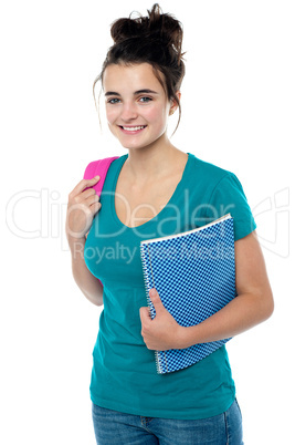 College student carrying backpack and spiral notebook