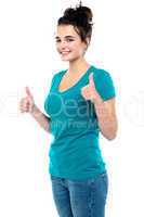 Gorgeous looking casual teenager showing double thumbs up