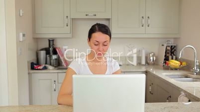 Woman typing at laptop and burglar suddenly appears