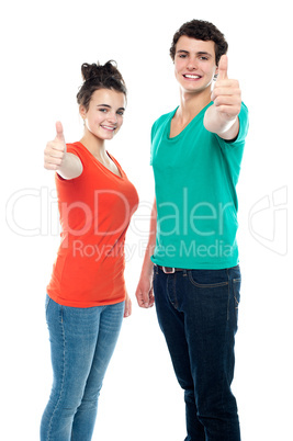 Teen love couple showing thumbs up to camera