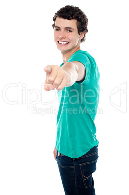 Young guy pointing you out with his stretched left arm