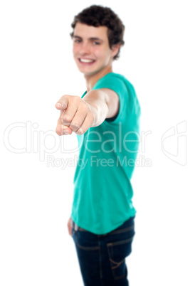 Casual teen guy pointing at you