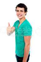 Cheerful teenager showing thumbs up to camera