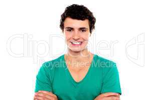 Stylish trendy guy posing with folded arms