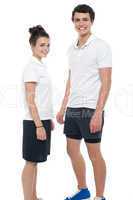 Teen couple in sportswear posing casually