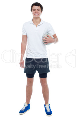 Energetic football player holding ball tightly
