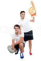 Cheerleader fan girl posing with football team player