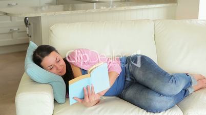 Pregnant woman enjoying reading a book