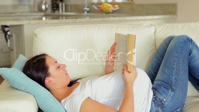 Pregnant woman relaxing and reading