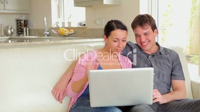 Couple sitting on the sofa and talking on video chat