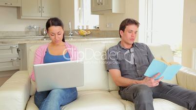 Woman shopping online asking husband for credit card