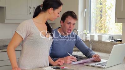 Couple checking bills with the laptop