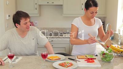 Woman preparing sandwches for lunch with husband