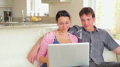 Couple watching movie on laptop