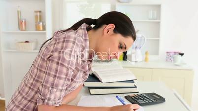 Woman studying with calculator