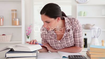 Studying woman with books and calculator