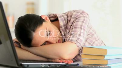 Woman napping in front of laptop