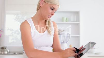 Woman happily shopping online with tablet computer