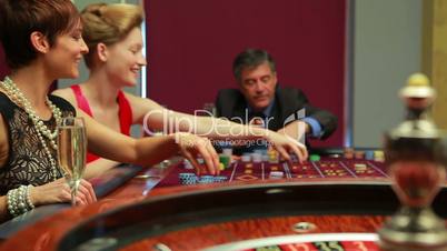 Women putting chips on table