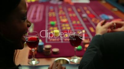 Woman talking to man while playing roulette